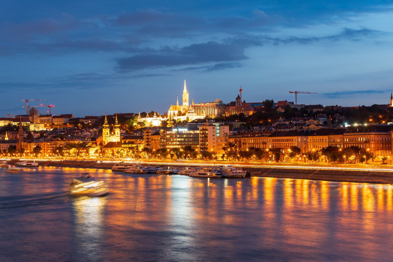 Budapest&rsquo;s Danube waterfront lit at twilight, a river many travelers ask us to quote