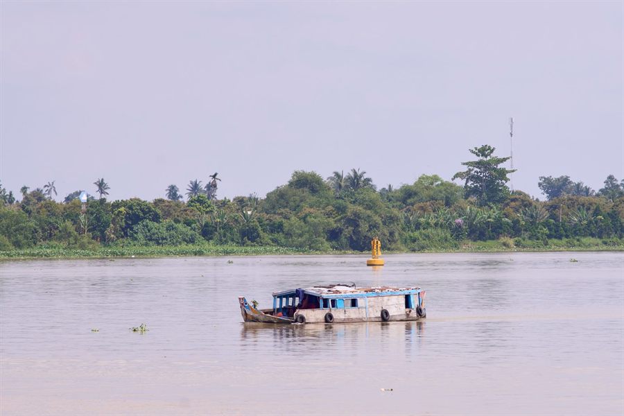 Small boat crossing the Mekong River near Vinh Long, Vietnam