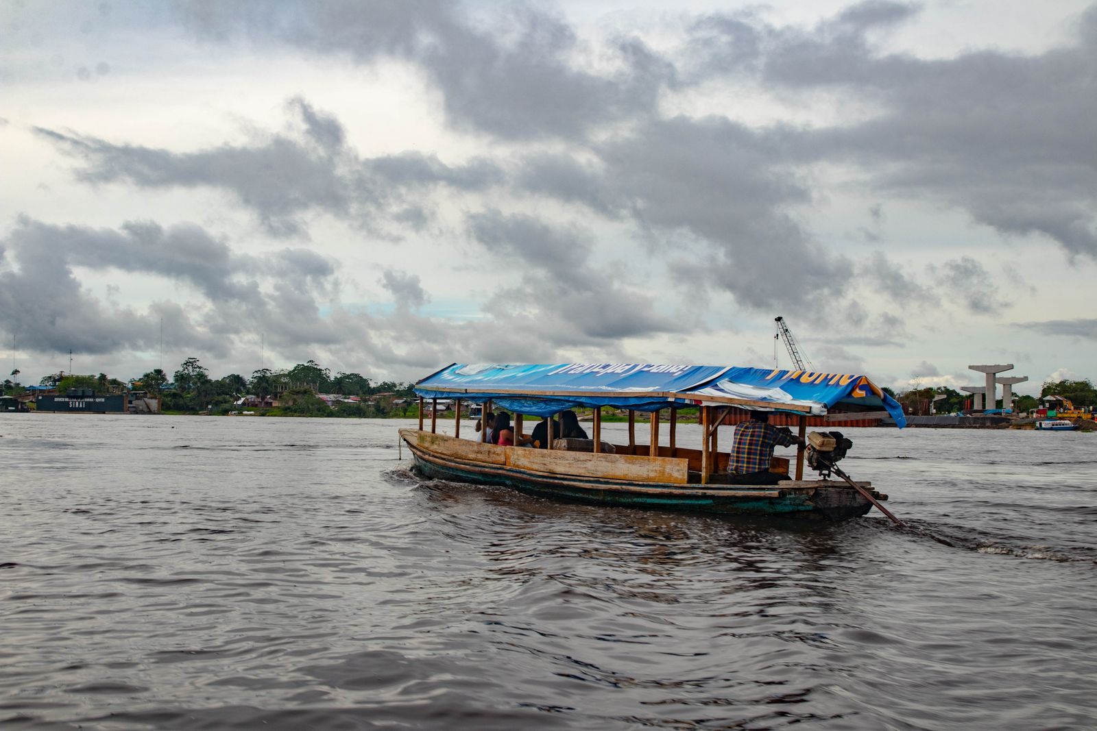 Covered riverboat on the Amazon near Iquitos, Peru, under a cloudy sky